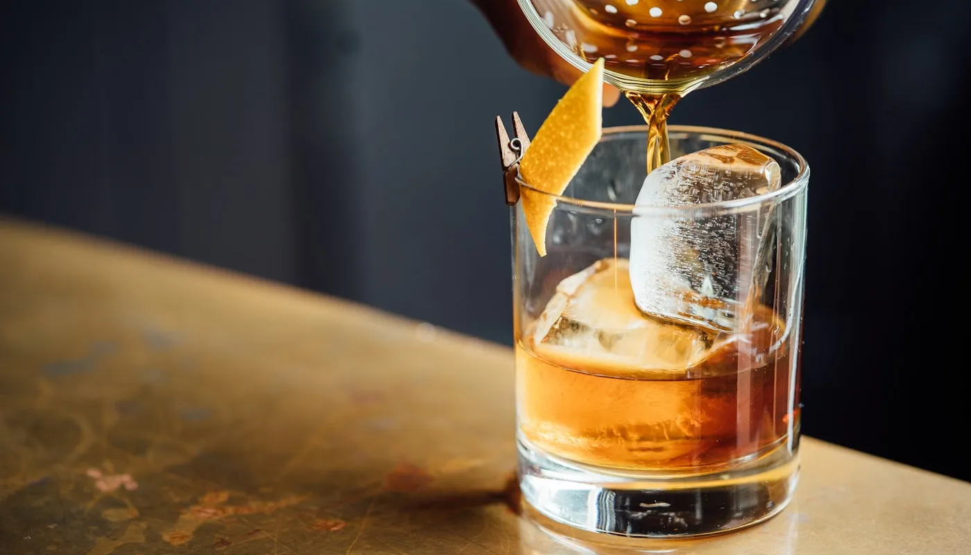 Cocktail being poured into a glass