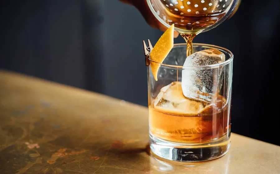 Cocktail being poured into a glass